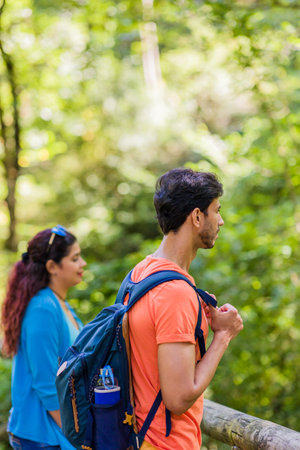 mixed race couple trekking in senda del oso, Asturias. Mid adult ecotourism in Proazaの写真素材