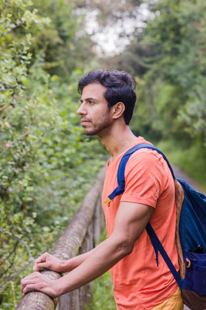 Hiker trekking in senda del oso Asturias a eco Tourism destination. South asian adult with backpackの写真素材