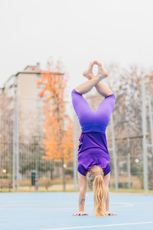 Sport fitness handstand exercise for calisthenics balance. Hispanic mid adult woman workoutの写真素材