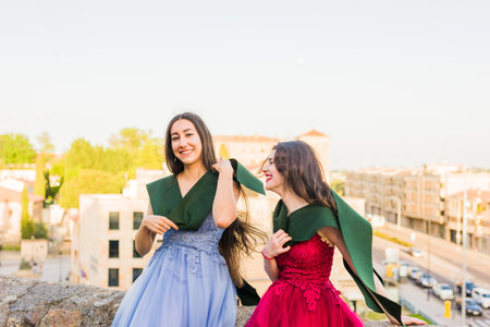Young Hispanic Students happy celebrating success graduation with stole in Salamanca, Spain.の写真素材