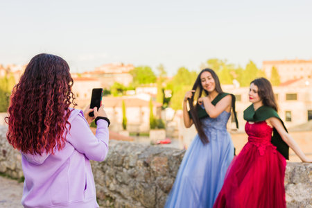 Graduation ceremony photography with smartphone for social media. Hispanic woman student. Salamancaの写真素材