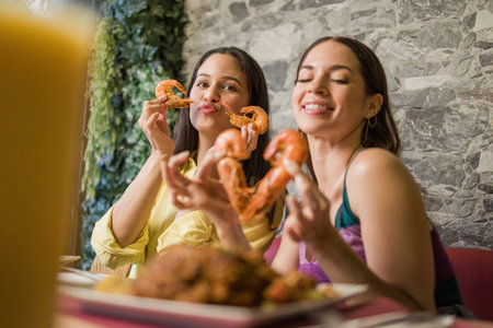 Women eating shrimps in ecuadorian restaurantの写真素材