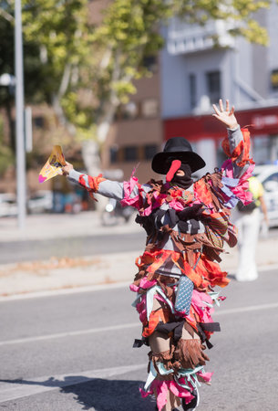 Person wearing colorful costume dancing during hispanicity day parade. Dia de la hispanidad