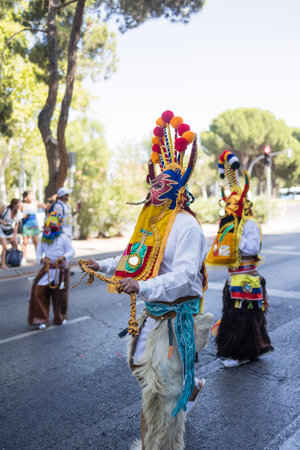 People wearing traditional costumes parading on hispanicity day. Dia de la hispanidad