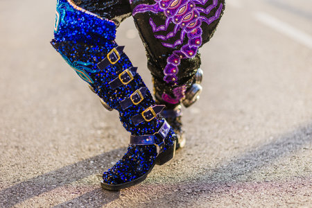 Dancer wearing glittery blue boots and embroidered pants during hispanic parade. Dia de hispanidadの写真素材