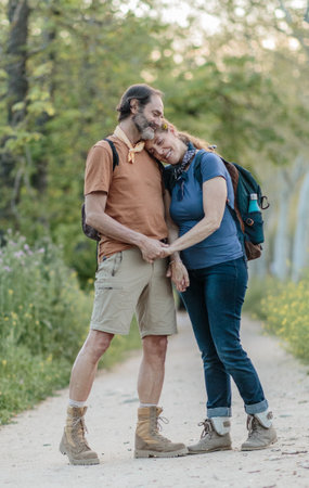 Senior couple holding hands while hikingの写真素材