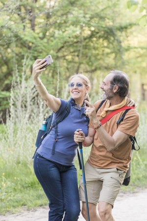 Hikers couple taking selfie while hiking in madridの写真素材