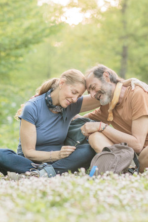 Senior couple embracing while hiking in nature, enjoying retirementの写真素材
