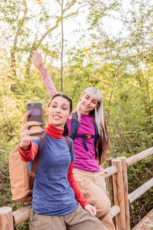 Hikers taking selfie while walking in forest