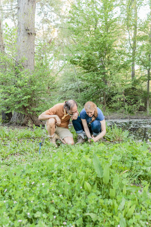 Biologists examining plants in retiro park, madrid