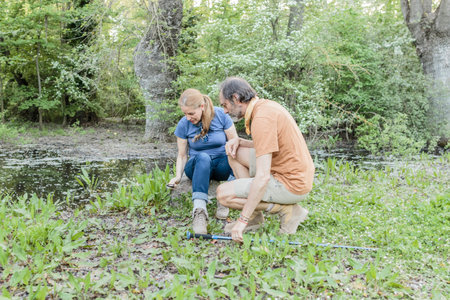 Biologists studying plants near a pond in madrid, spain