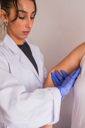 Doctor performing breast examination for cancer detection