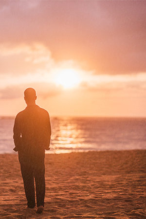 Young man enjoying solitude and inspiration on beach