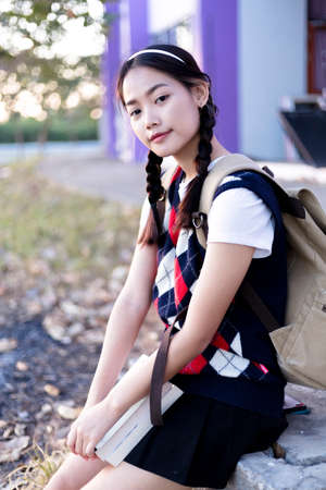 Young student, she carried books and carried her bag to studの写真素材