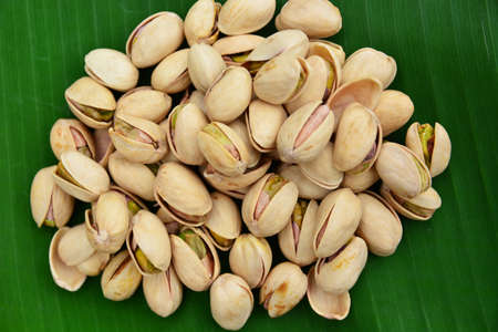 Roasted peanut pistachio and placed on a green banana leafの写真素材