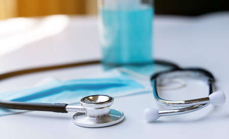 Medical tool stethoscope alcohol and a surgical mask on the side.の写真素材