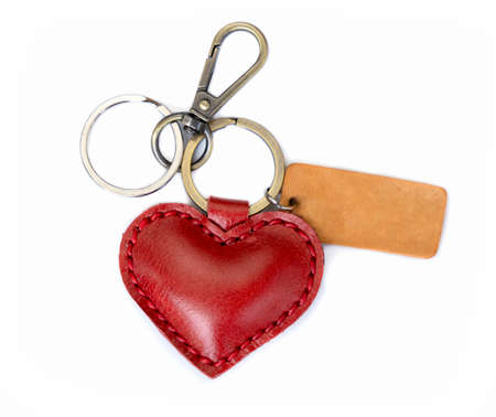 key chain is made of red heart-shaped leather. isolated white backgroundの写真素材