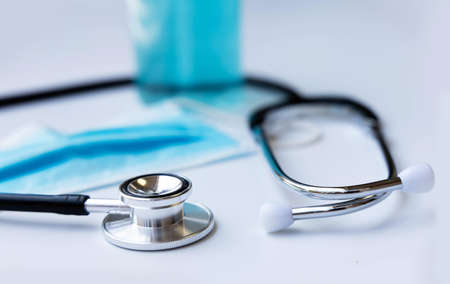 stethoscope a bottle alcohol and a mask are placed behind it.の写真素材