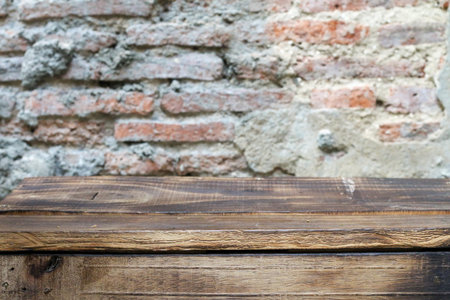 Distressed wooden floor with rough red brick cement wall, vintage look