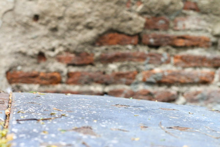 Old wooden floor meets red brick cement wall, perfect for product displayの写真素材