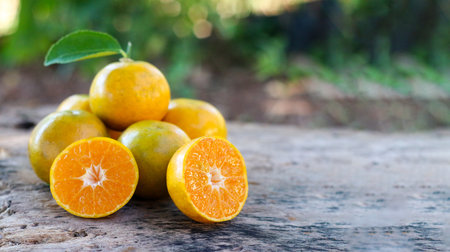 Sliced oranges on rough wooden planks, warm tones and clean layout. copy scapeの写真素材
