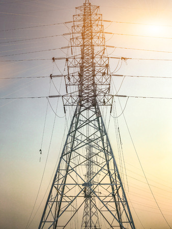 High voltage towers and bright sunsets.の写真素材