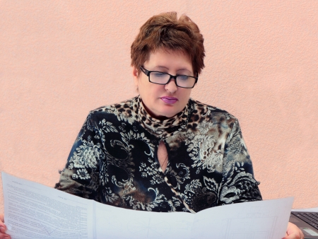 Business woman behind viewing the drawings の写真素材