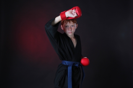 Teenager karate blue belt works off technique an attack while wearing gloves の写真素材