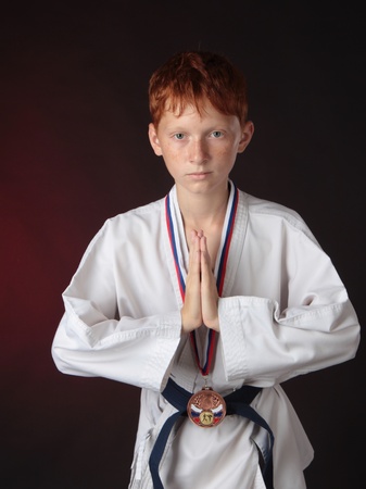 Medalist of - karate man with a medal is in a special traditional pose の写真素材