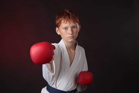 Teenager karate blue belt works off technique an attack while wearing gloves の写真素材