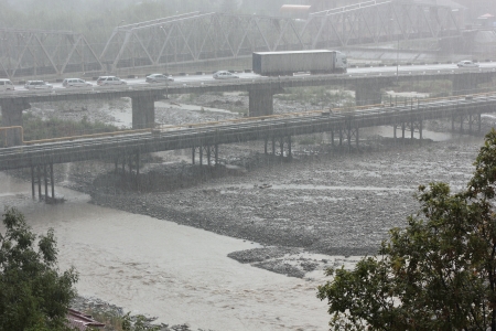 Strong rain caught unawares people and cars on the bridge of the southern of the city の写真素材