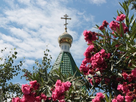 Upper part of a religious building with a dome and a cross in the settlement on the Black Sea coast の写真素材