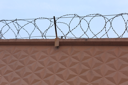 Serious obstacle to the criminals and criminals on light concrete wall.の写真素材