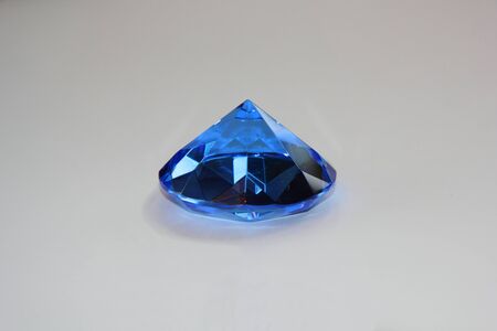 The multi-faceted figure in the shape of a pyramid made of colored organic glassの写真素材