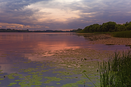 Evening colors of the sky and its reflection in the surface of the river.の写真素材