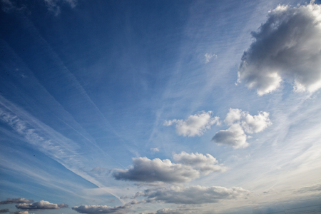 Beautiful blue sky with clouds of various shapes and colors.の写真素材