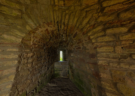 A narrow but long passage in a thick old stone wallの写真素材