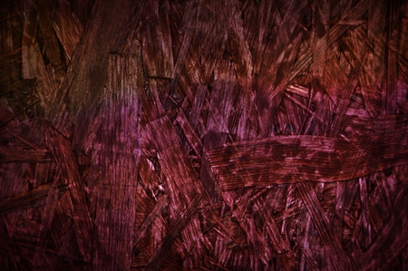 Burgundy red chipboard particle board desk surface wooden background textureの写真素材