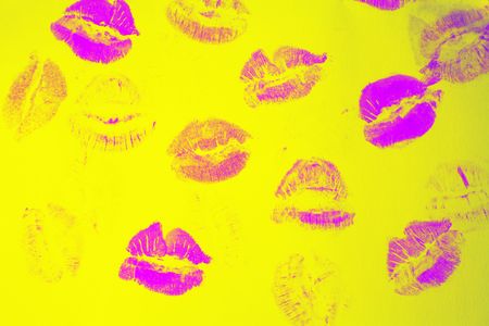 Abstract purple lipstick kisses on yellow art backgroundの写真素材