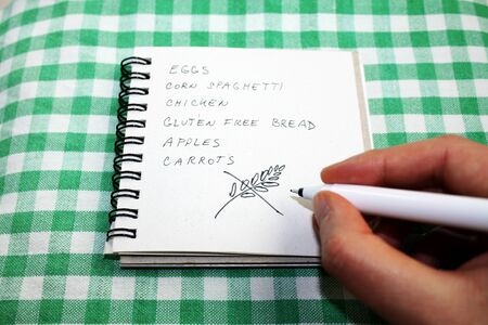 No gluten diet shopping list with a hand, which writing inscription gluten freeの写真素材