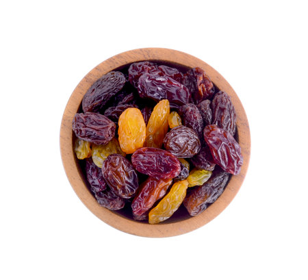 wood bowl Raisins isolated on white background.の写真素材