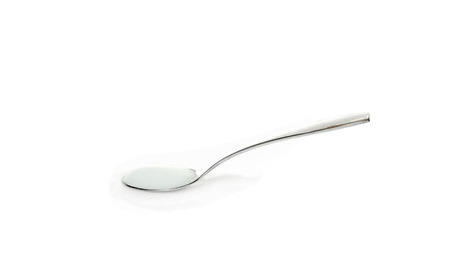 Salt spoon on white backgroundの写真素材