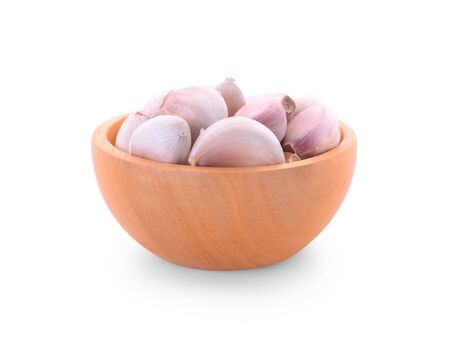 wood bowl with garlic on white backgroundの写真素材