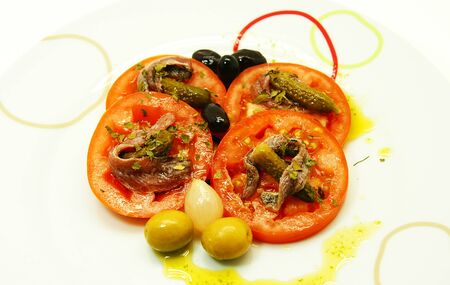 slices of tomato with gherkin and anchovyの写真素材