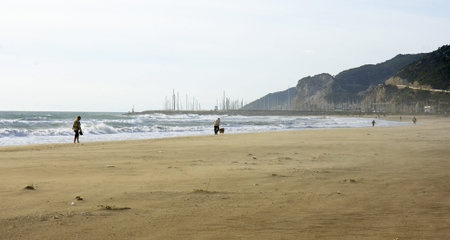 Man stroll Castelldefels s beach, Barcelona, a wind day
