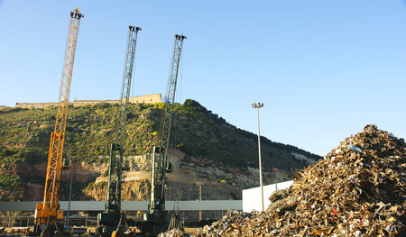 cranes and scrap at a dock in the port of Barcelonaの写真素材
