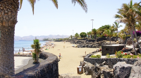 Beach, tourists and palm trees in Puerto del Carmen, Lanzarote, Canary Islandsのeditorial素材