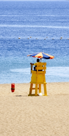 Beach, tourists and palm trees in Puerto del Carmen, Lanzarote, Canary Islandsの写真素材