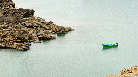 Green boat on a beach in Arrecife, Lanzarote, Canary Islandsの写真素材