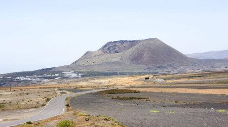 Volcanic landscape with road in Lanzarote, Canary Islandsの写真素材